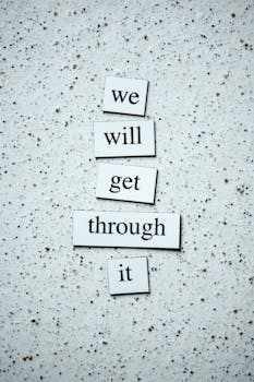 Motivational message "we will get through it" on a textured background for encouragement.