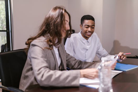Two professionals engaged in a corporate meeting, sharing ideas and insights.