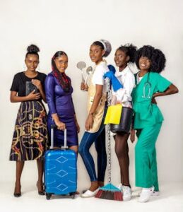A group of five women showcasing diverse professions in a studio setting with a white background.