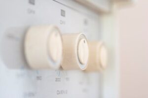 Artistic close-up of stove control knobs, highlighting design details in a kitchen setting.
