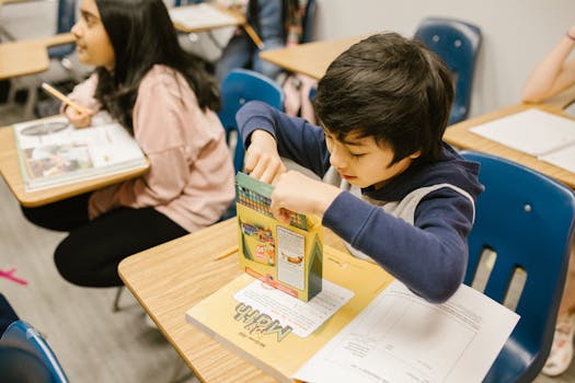 Children engaged in learning activities in a classroom, showcasing school life.