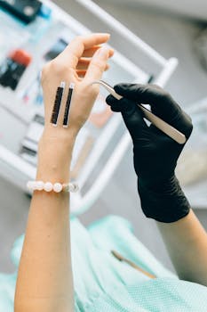 Close-up of a professional applying eyelash extensions in a beauty salon setting.