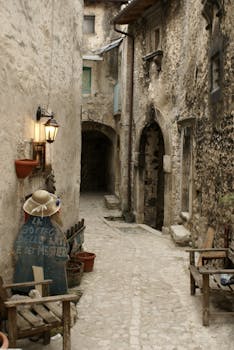 Explore a charming narrow alley in Italy with historic stone architecture and vintage ambiance.